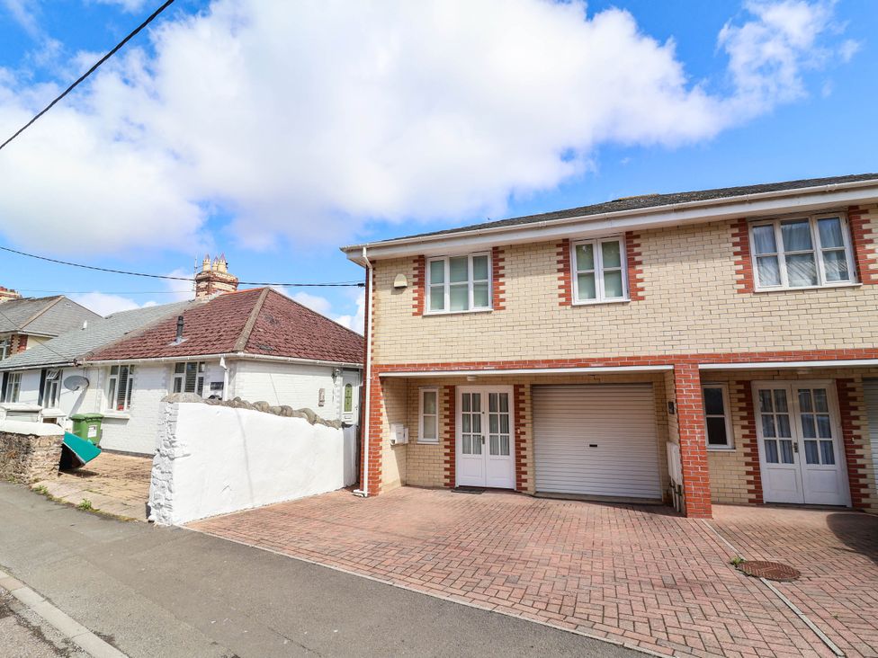 A house with a garage and driveway at 1 Tideways in Bideford