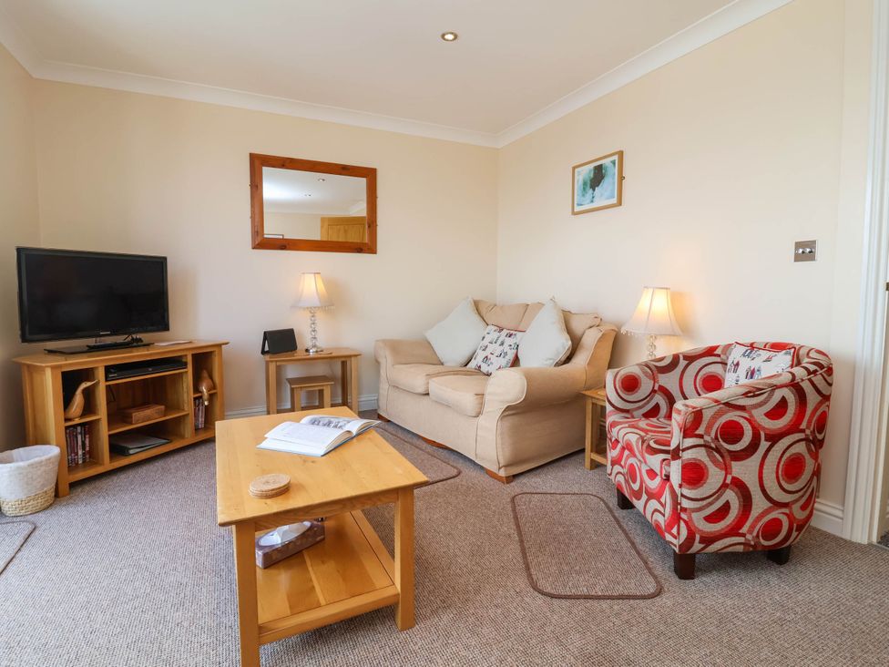 A living room with a sofa and television at 1 Tideways in Bideford