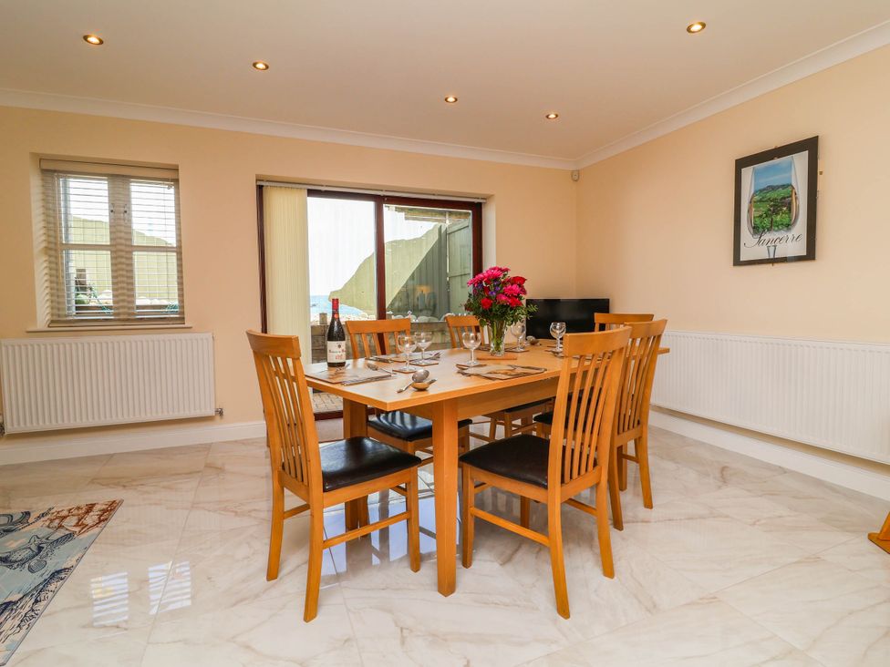 A dining room with a table and chairs at 1 Tideways in Bideford