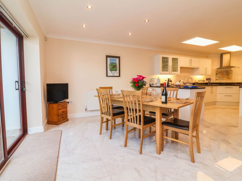 A dining room with a table set for dinner at 1 Tideways Bideford