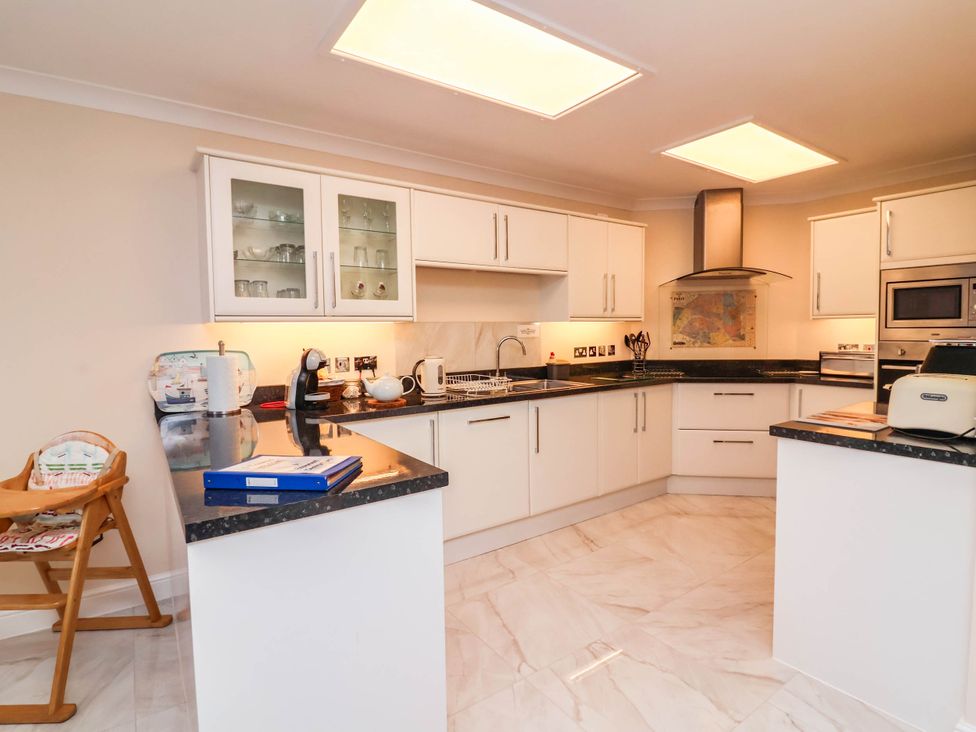 A kitchen with a countertop and appliances at 1 Tideways Bideford