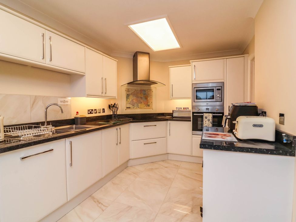 A kitchen with cabinets and appliances at 1 Tideways Bideford