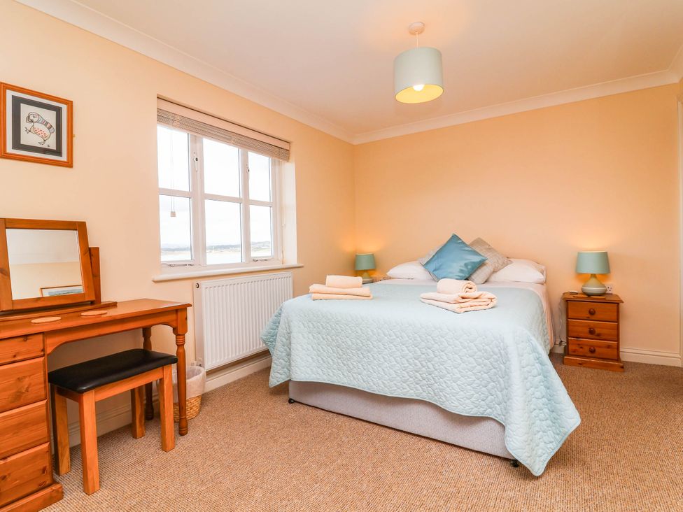 A bedroom with a bed and a dresser at 1 Tideways in Bideford