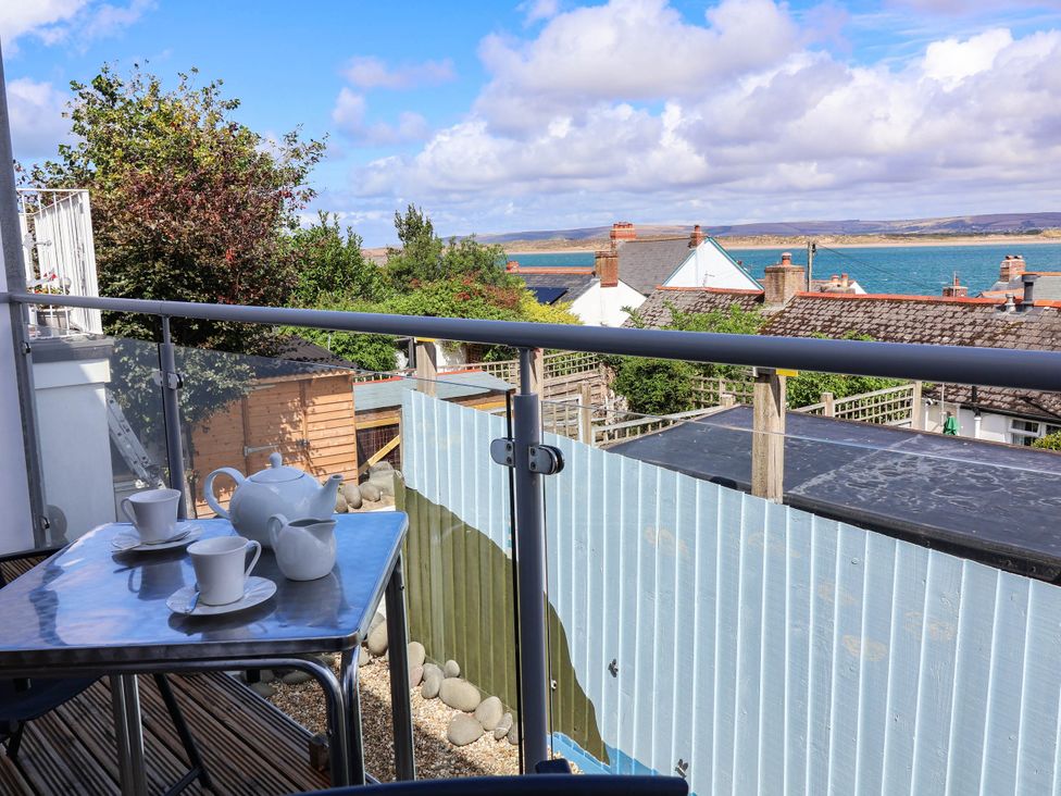 A balcony with a table set for tea at 1 Tideways Bideford