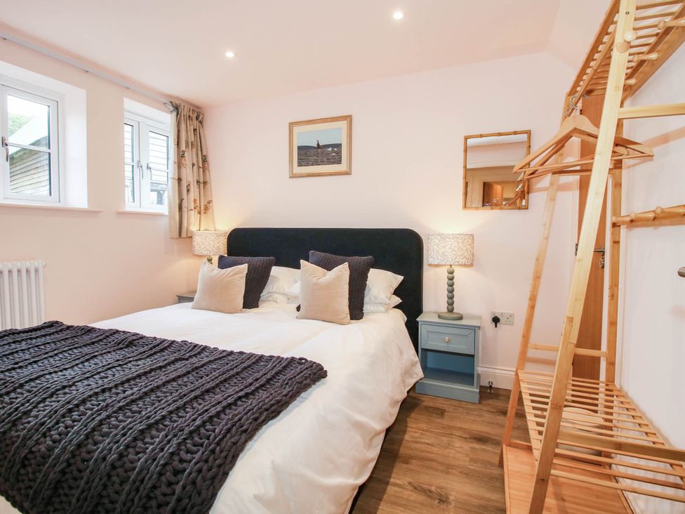 A bedroom with a bed and nightstand at Little Red Barn Wallop near Westbury