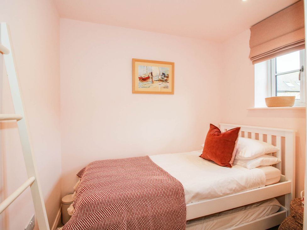 A bedroom with a bed and window at Little Red Barn in Wallop near Westbury