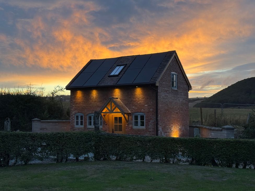A house with solar panels and windows at Little Red Barn in Wallop near Westbury