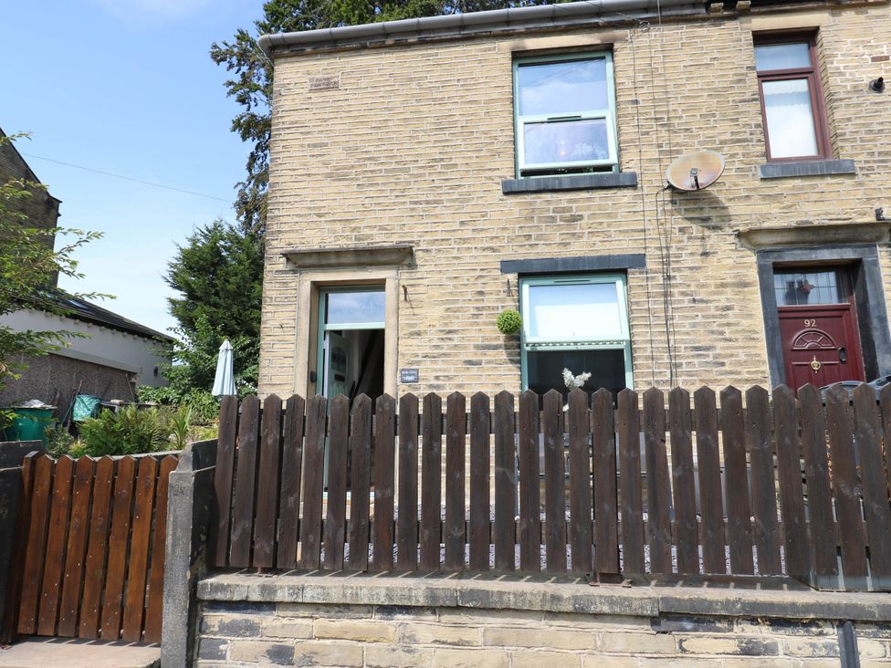 A house with windows and a fence at Brodie Cottage in Brighouse