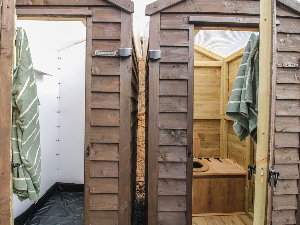 A bathroom with shower and toilet stalls at Darn Mawr 