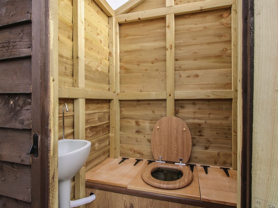 A bathroom with a toilet and sink at Darn Mawr in 