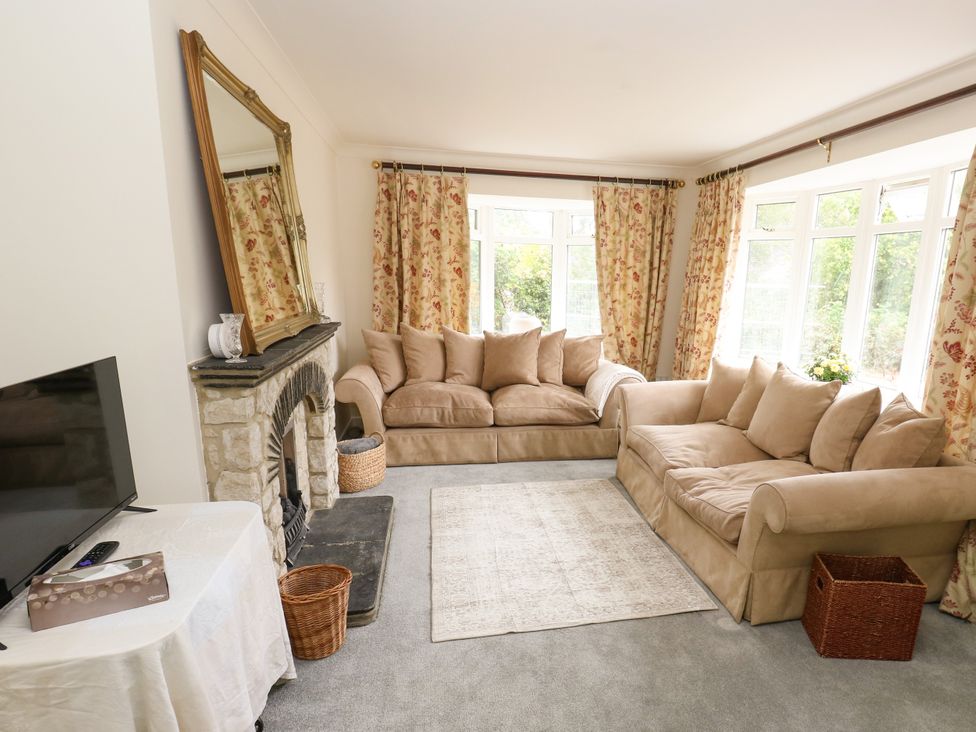 A living room with a sofa and television at 12 The Dell in Bardsey near Wetherby