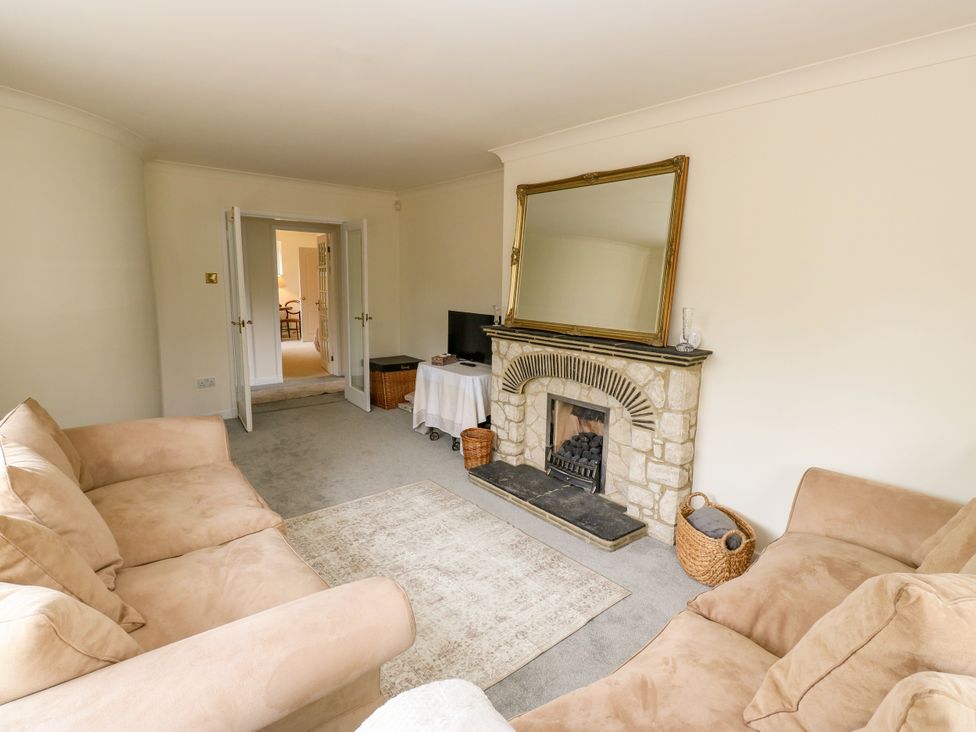 A living room with a fireplace and television at 12 The Dell Bardsey near Wetherby