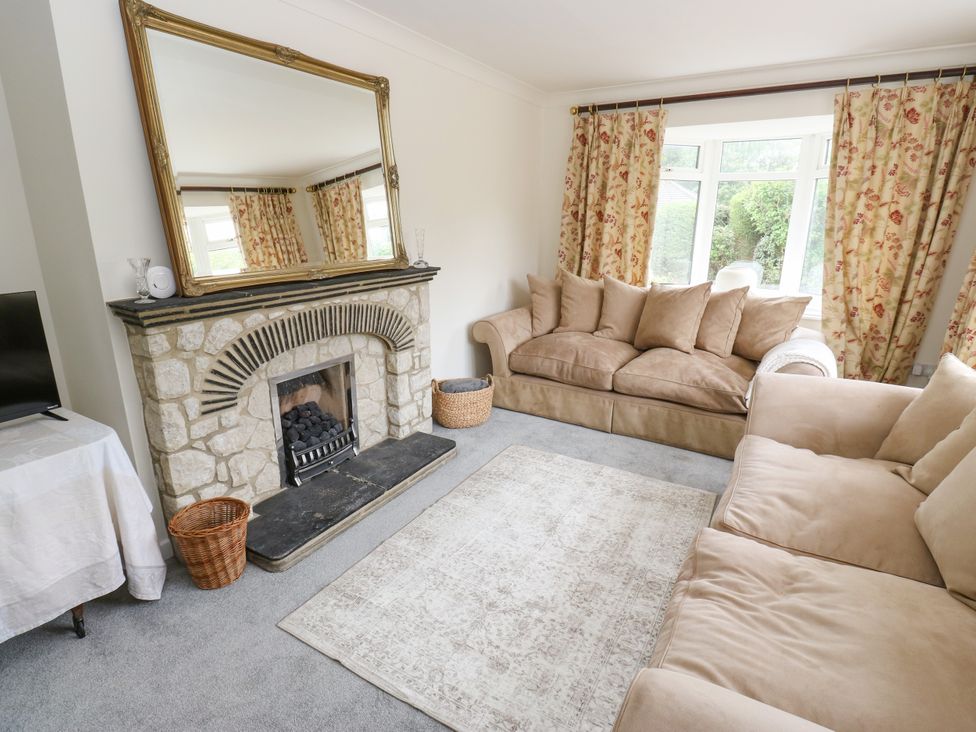 A living room with a sofa and a fireplace at 12 The Dell in Bardsey near Wetherby