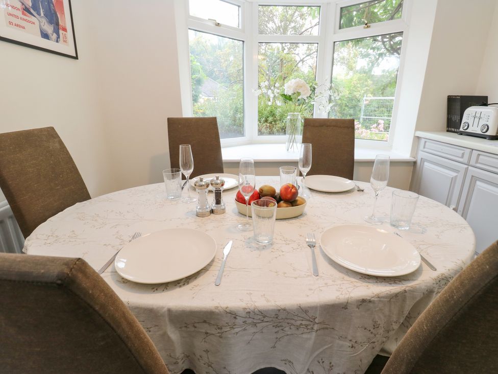 A dining table set with plates and glasses at 12 The Dell in Bardsey near Wetherby