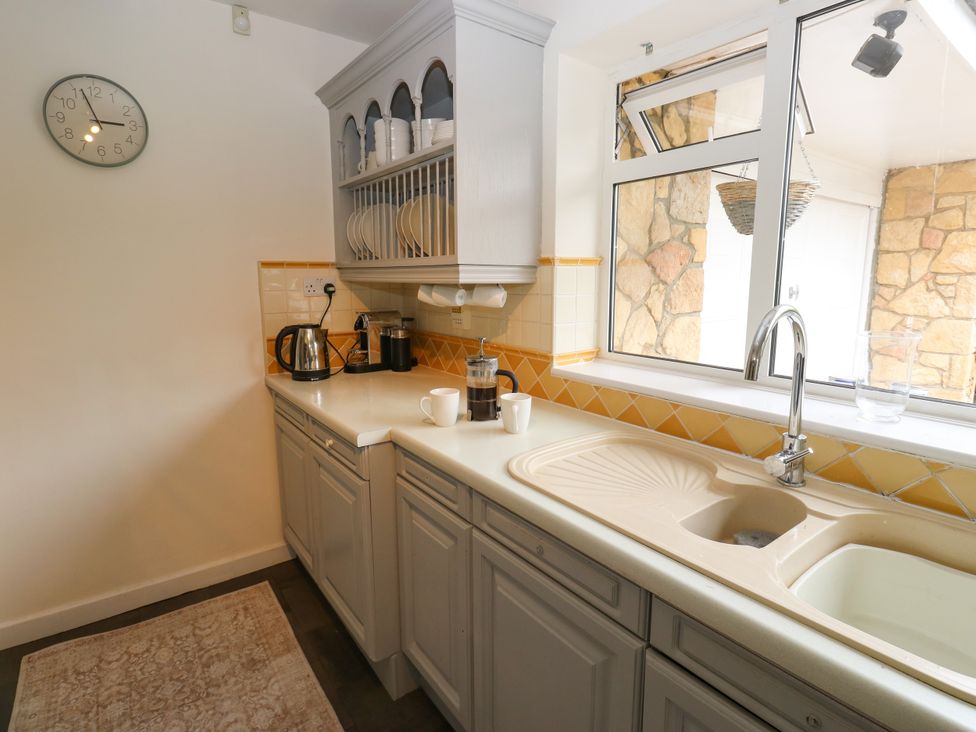 A kitchen with a sink and appliances at 12 The Dell in Bardsey near Wetherby