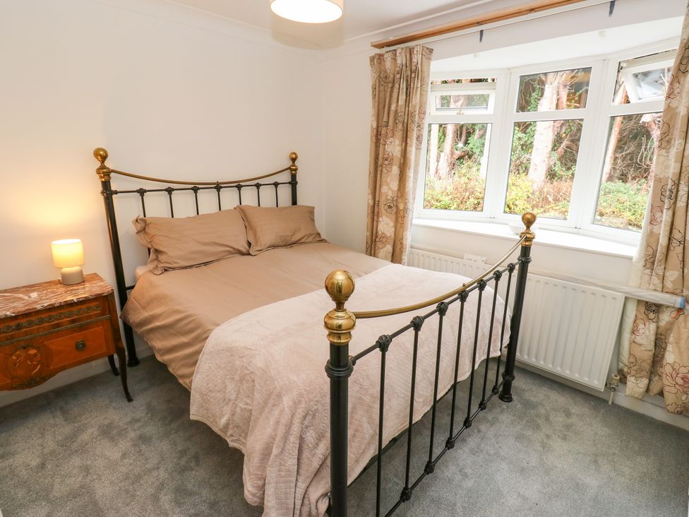 A bedroom with a bed and bedside table at 12 The Dell in Bardsey near Wetherby