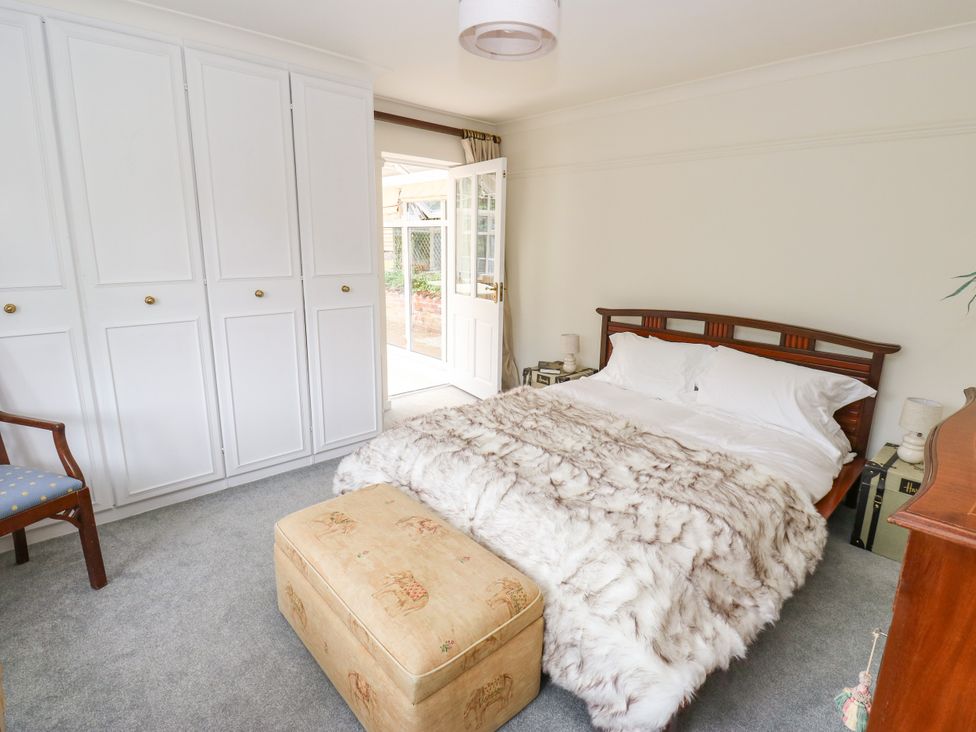 A bedroom with a bed and wardrobe at 12 The Dell Bardsey near Wetherby