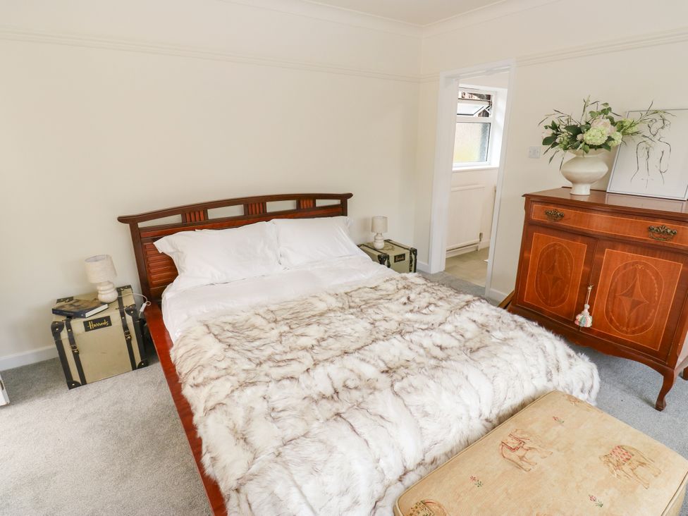 A bedroom with a bed and chest of drawers at 12 The Dell Bardsey near Wetherby