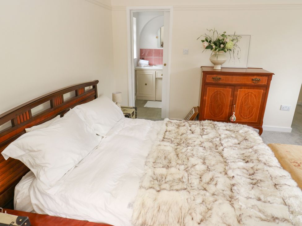 A bedroom with bed and chest of drawers at 12 The Dell in Bardsey near Wetherby