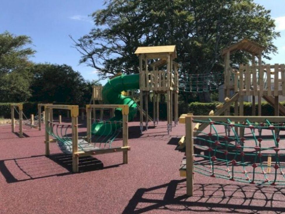 A playground with a slide and climbing frame at Glendale holiday park in Wigton