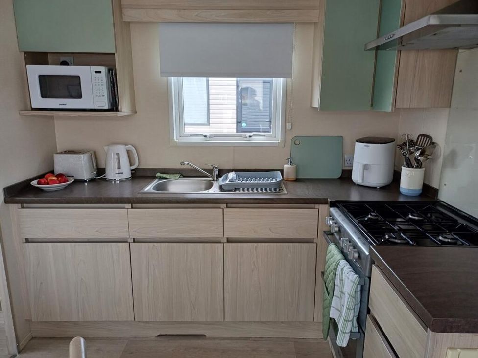A kitchen with appliances and utensils at Glendale holiday park in Wigton