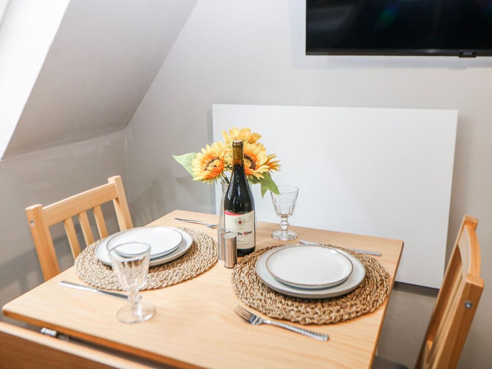 A dining room with a table set for two at Little Mill in Ashover