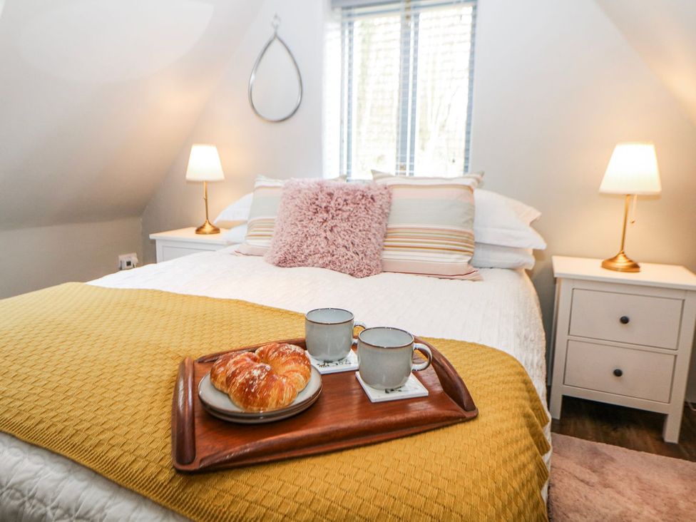 A bedroom with a bed and breakfast tray at Little Mill in Ashover
