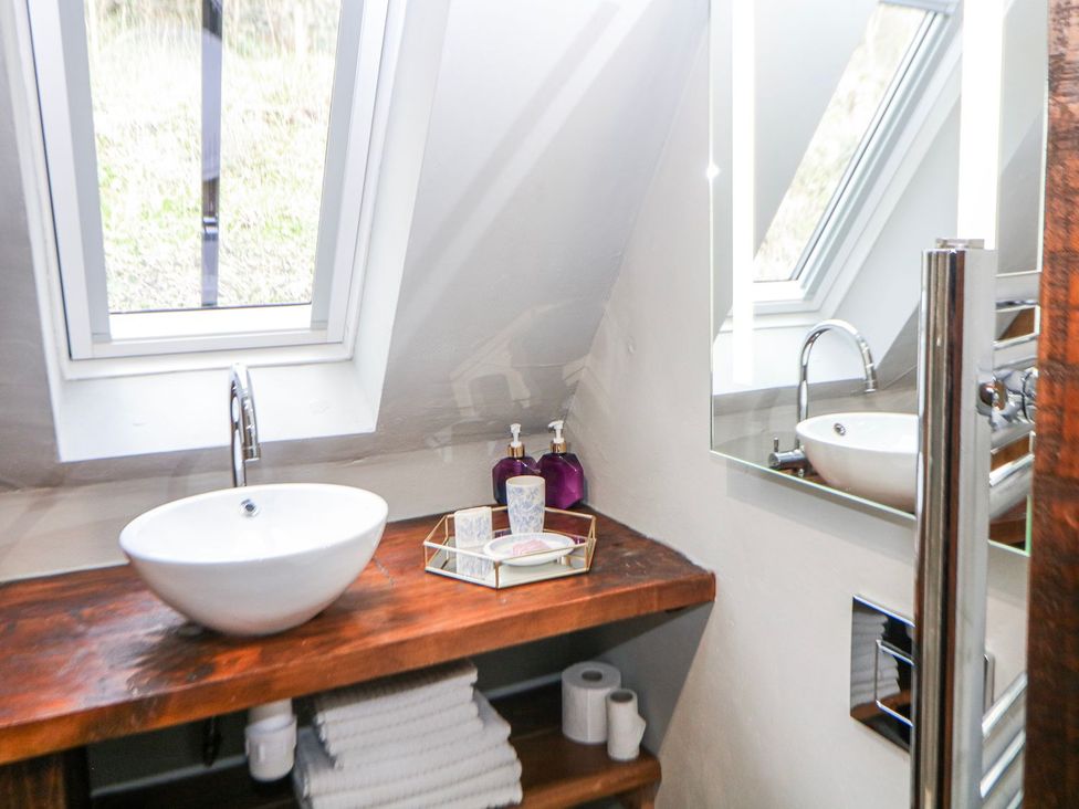 A bathroom with a sink and mirror at Little Mill in Ashover