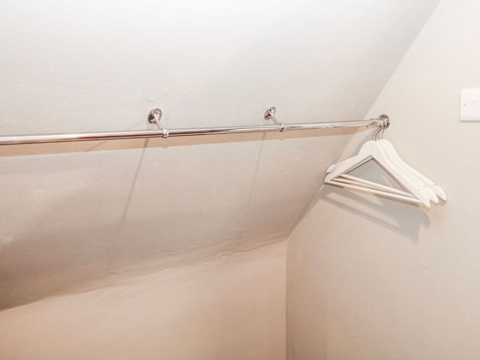 A closet with a clothes rail and hangers at Little Mill in Ashover