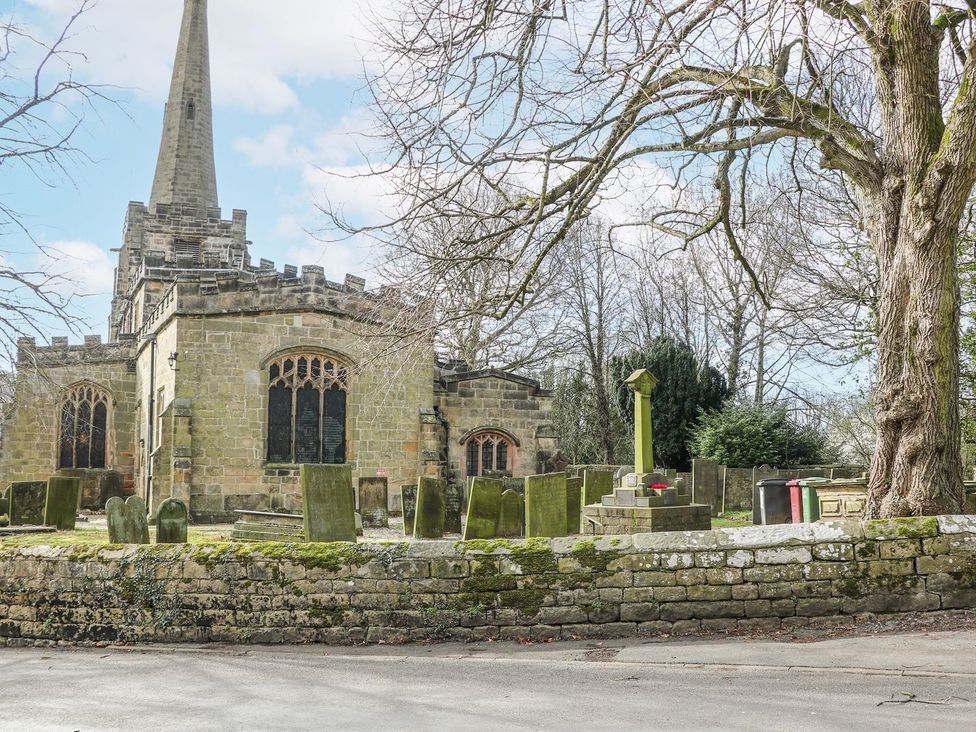 A church and graveyard with tombstones at Little Mill in Ashover