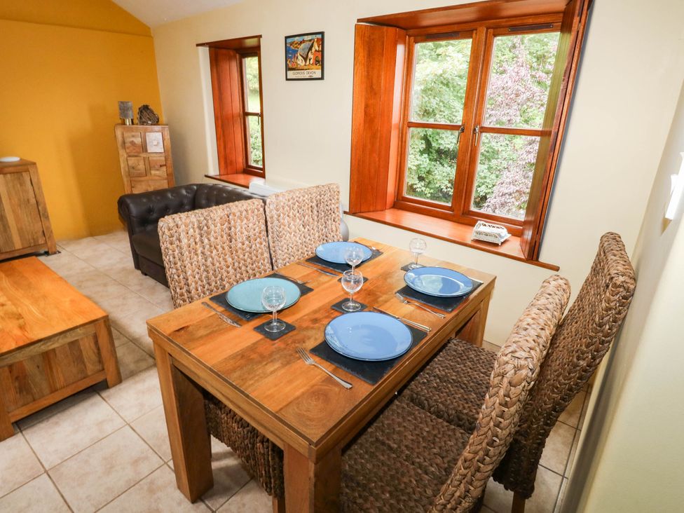 A dining room with a table and chairs at The Old Forge in Kingsbridge