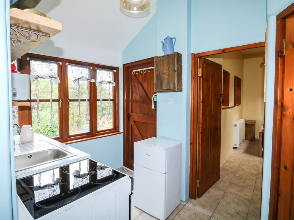 A kitchen with a sink, stove, and refrigerator at The Old Forge in Kingsbridge
