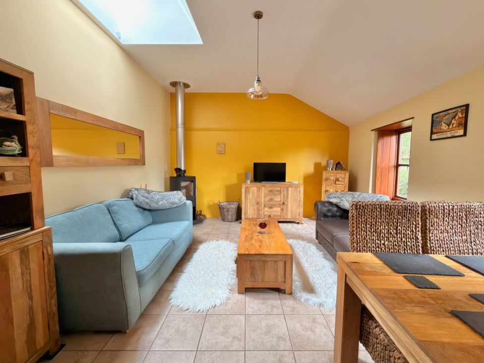 A living room with a sofa and coffee table at The Old Forge in Hallsands