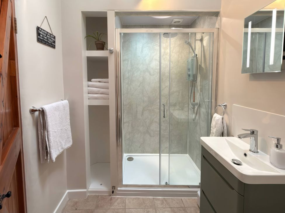 A bathroom with a shower and sink at The Old Forge in Hallsands