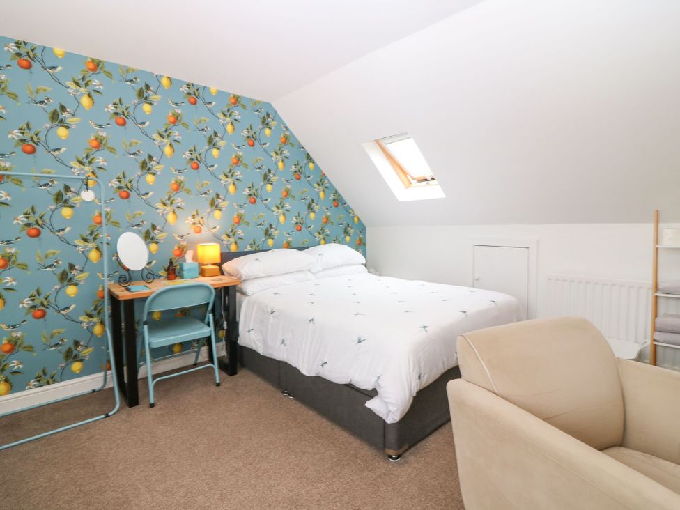 A bedroom with a bed and desk at Hill View Studio in Hawick