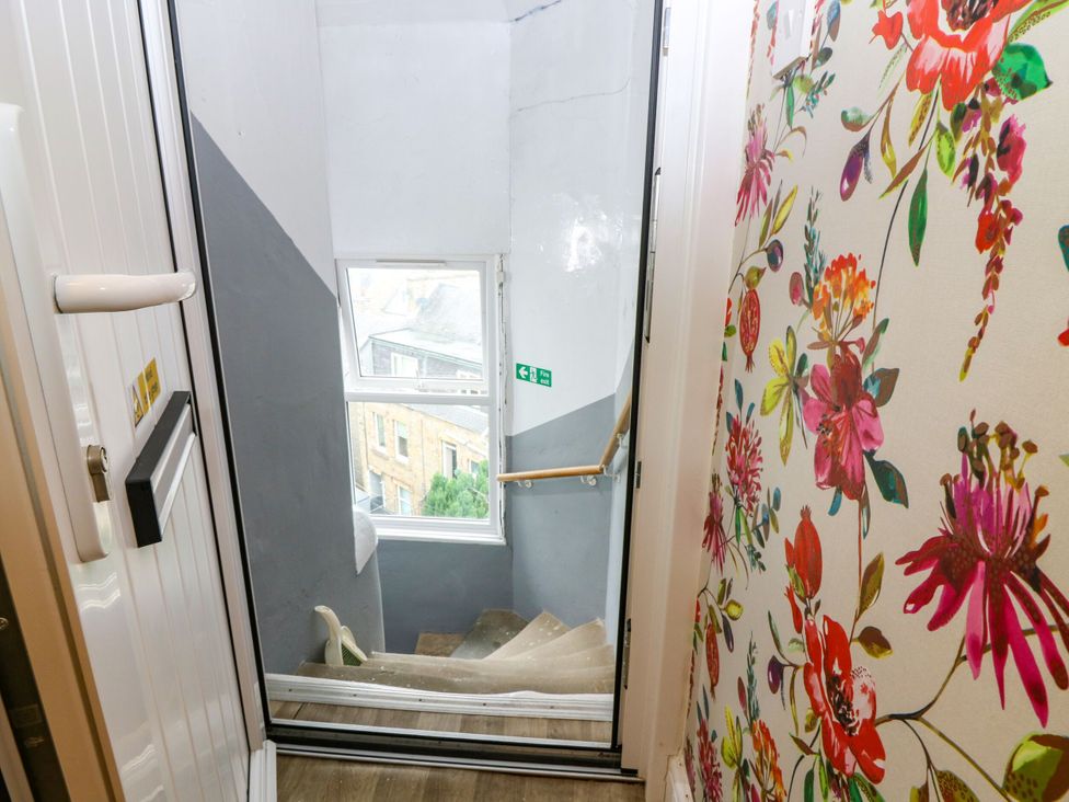 A staircase with a door and window at Hill View Studio in Hawick