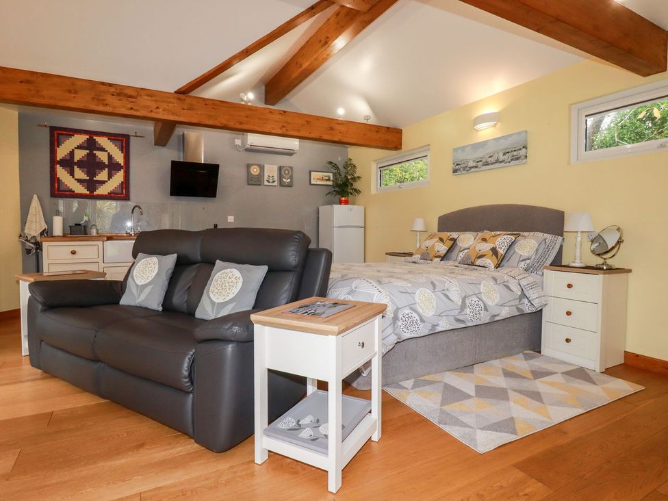 A living room with a sofa and bed at Brambleside Lodge in Truro