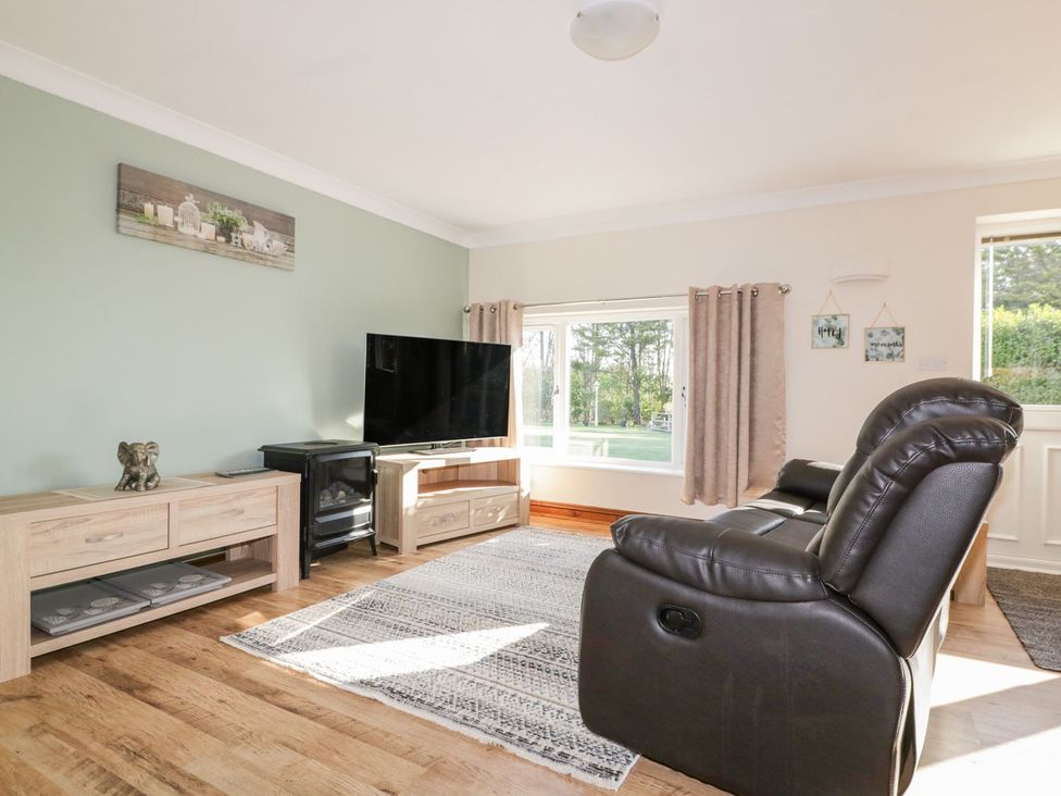 A living room with a television and a sofa at Lower Brambleside in Truro