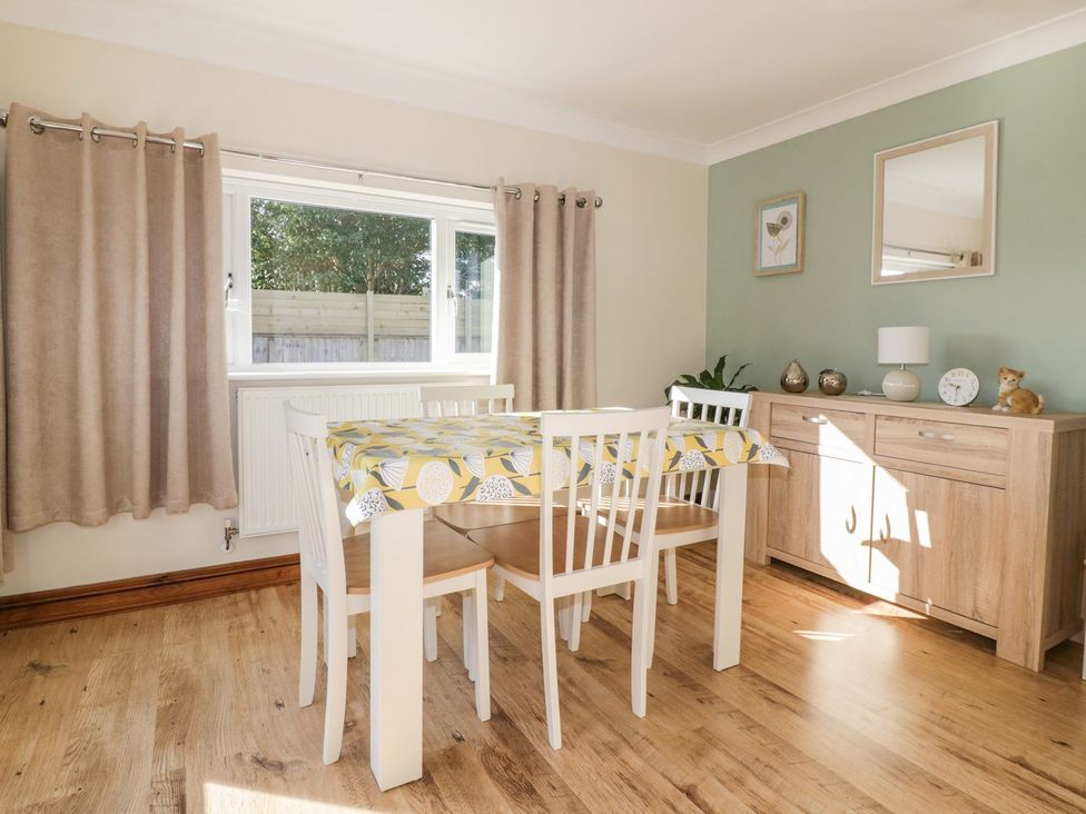 A dining room with a table and chairs at Lower Brambleside in Truro