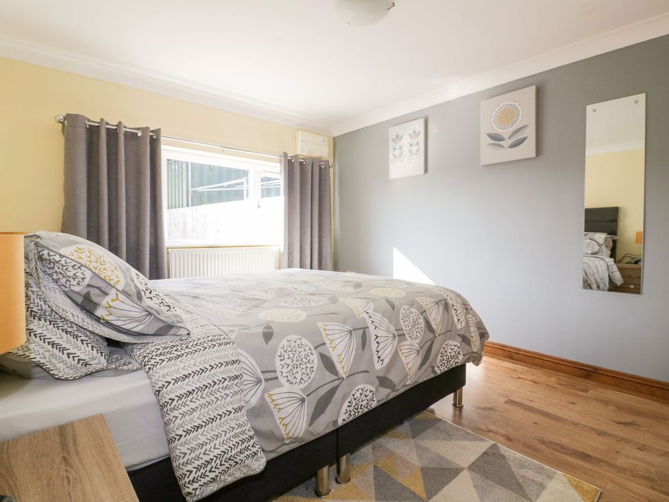 A bedroom with a bed and window at Lower Brambleside in Truro
