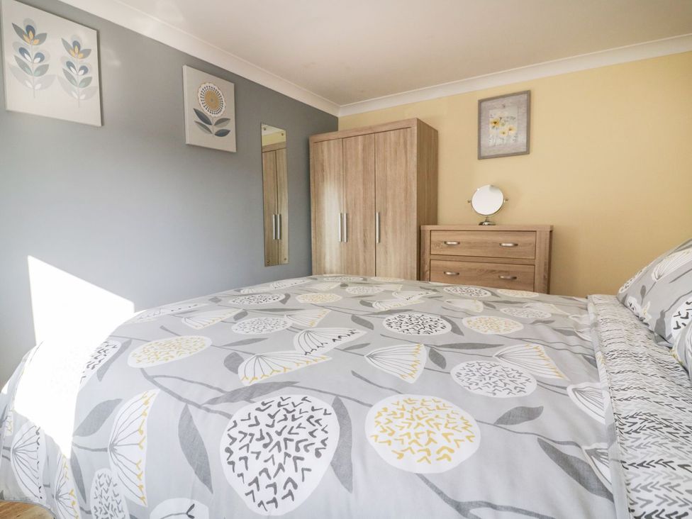 A bedroom with a bed and furniture at Lower Brambleside in Truro