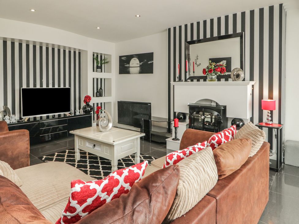 A living room with a sofa and coffee table at Mourne Mountains View in Dunmurry