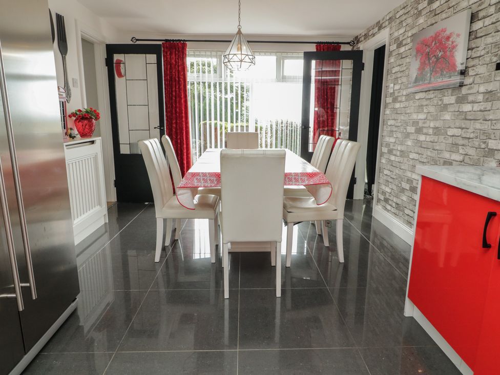 A dining room with a table and chairs at Mourne Mountains View Dunmurry