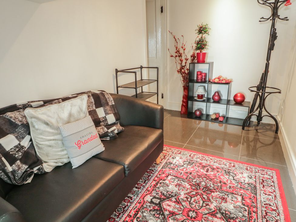 A living room with a sofa and a shelf at Mourne Mountains View in Dunmurry