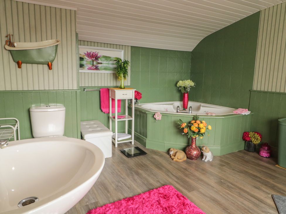 A bathroom with a bathtub, toilet, and sink at Mourne Mountains View, Dunmurry