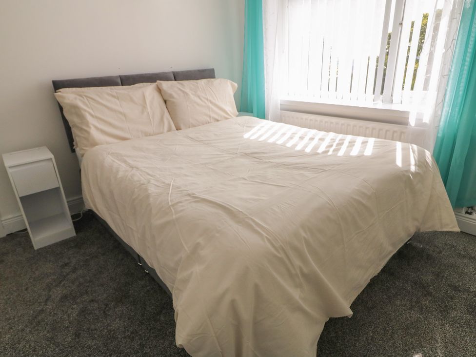 A bedroom with a bed and a bedside table at Mourne Mountains View in Dunmurry