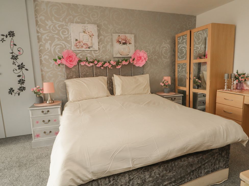 A bedroom with a bed and wardrobe at Mourne Mountains View in Dunmurry