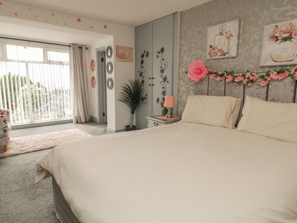 A bedroom with a bed and sliding door at Mourne Mountains View in Dunmurry