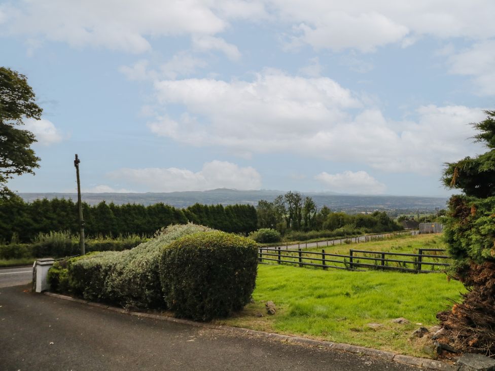 An outdoor area with grass and a fence at Mourne Mountains View in Dunmurry