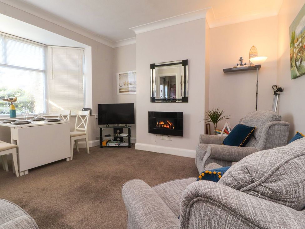 A living room with a sofa and dining table at Lytham House in Lytham St. Annes